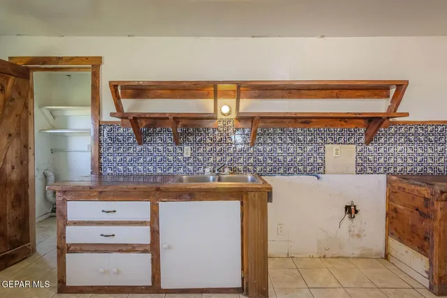 a view of a porch with wooden floor and furniture