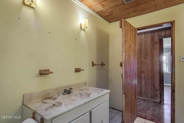 a view of an empty room with closet and a window