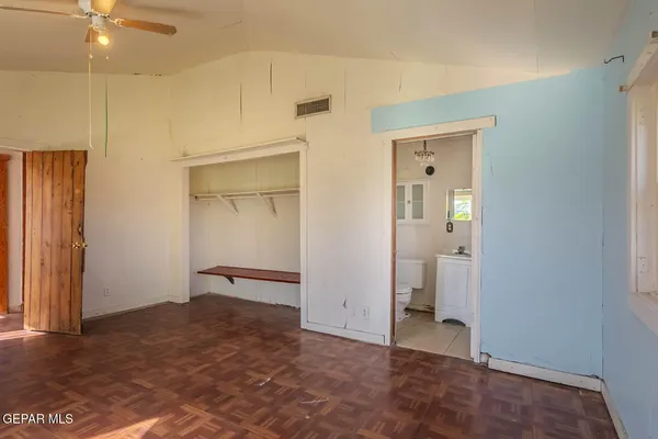 a bathroom with a toilet a sink a mirror and a window