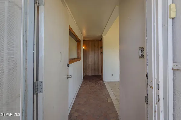 a view of a hallway with wooden shelves