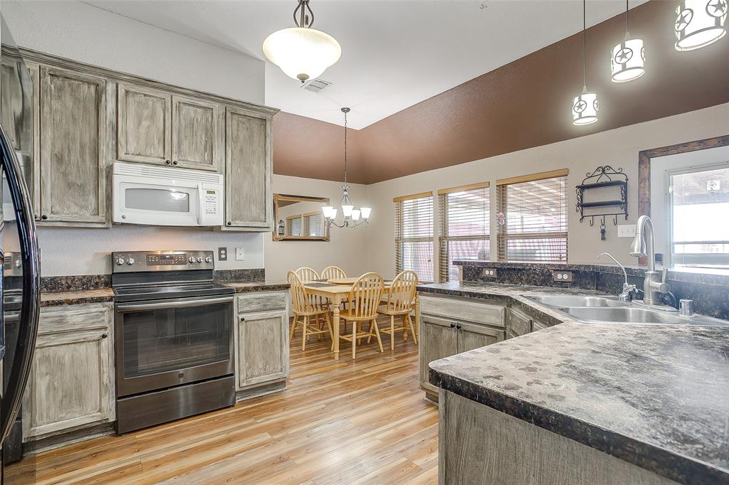 10905 Soft Shell Drive Venus, TX 76084 - Photo 12 of 21 a kitchen with lots of counter top space and stainless steel appliances
