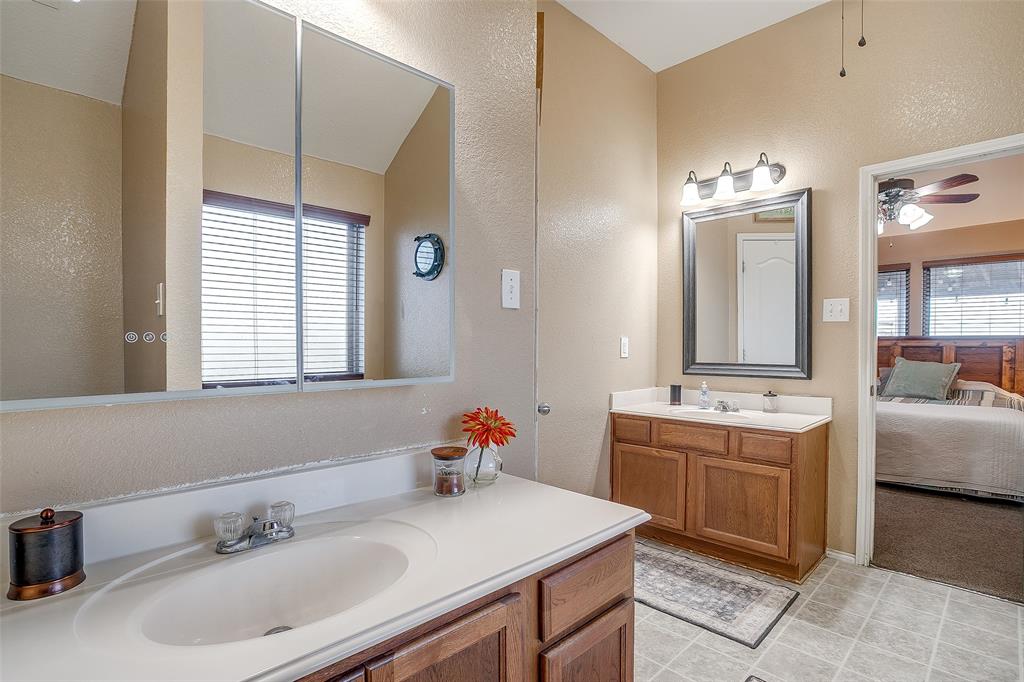 10905 Soft Shell Drive Venus, TX 76084 - Photo 17 of 21 a en suite bathroom with a sink double vanity granite and a mirror