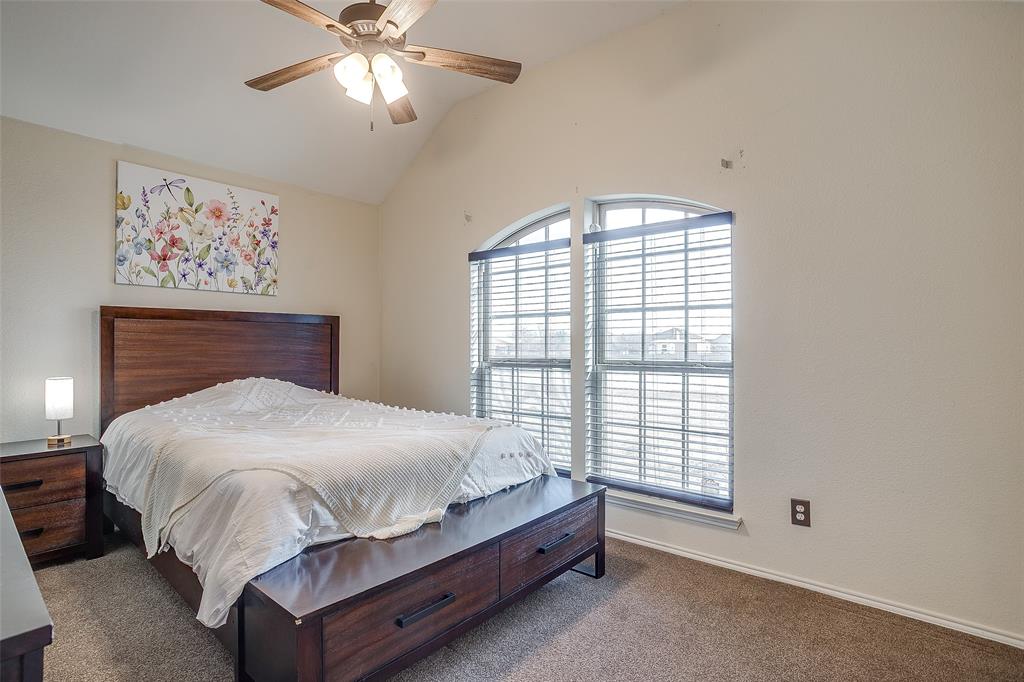 10905 Soft Shell Drive Venus, TX 76084 - Photo 18 of 21 a bed sitting in a bedroom next to a window