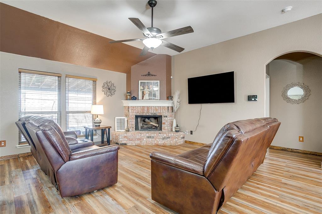 10905 Soft Shell Drive Venus, TX 76084 - Photo 7 of 21 a living room with furniture fireplace and a flat screen tv