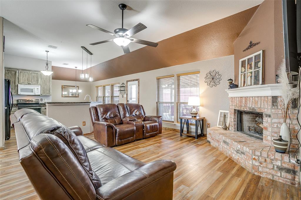 10905 Soft Shell Drive Venus, TX 76084 - Photo 9 of 21 a living room with furniture and a fireplace