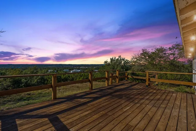 a view of a balcony with wooden floor and city view