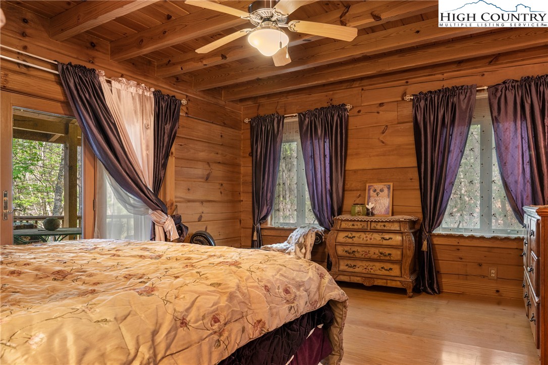 286 B Howell Road Lansing, NC 28643 - Photo 16 of 47 a bedroom with a bed and a chandelier