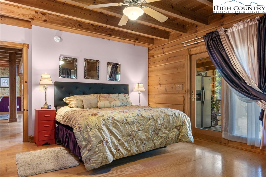 286 B Howell Road Lansing, NC 28643 - Photo 17 of 47 a bedroom with a bed and a mirror