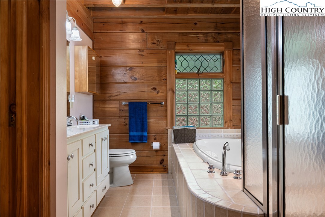 286 B Howell Road Lansing, NC 28643 - Photo 18 of 47 a bathroom with a toilet a sink and a large mirror
