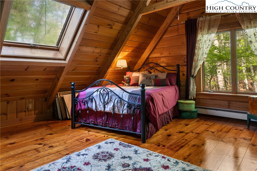 286 B Howell Road Lansing, NC 28643 - Photo 26 of 47 a bedroom with a bed and a window