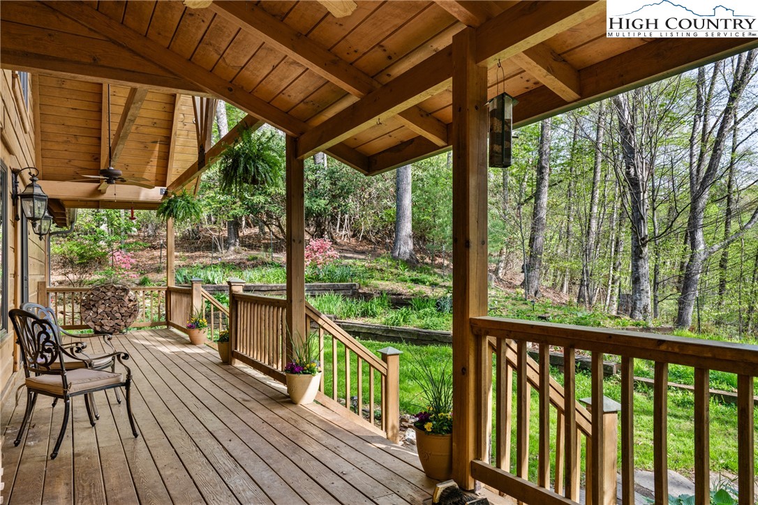 286 B Howell Road Lansing, NC 28643 - Photo 34 of 47 a view of a balcony with chairs and wooden floor