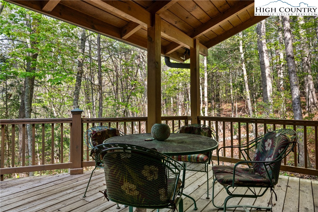 286 B Howell Road Lansing, NC 28643 - Photo 38 of 47 a view of a balcony with chairs and wooden floor