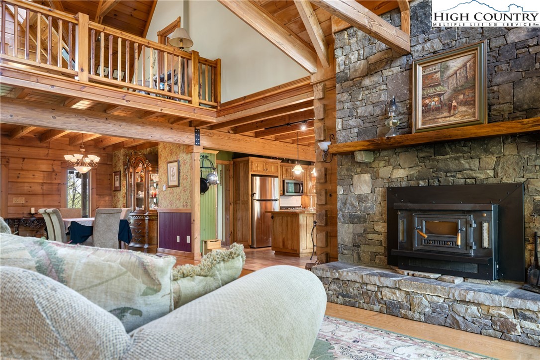 286 B Howell Road Lansing, NC 28643 - Photo 4 of 47 a living room with furniture a flat screen tv and a fireplace