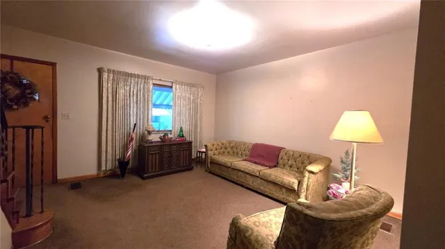 a living room with furniture and a lamp