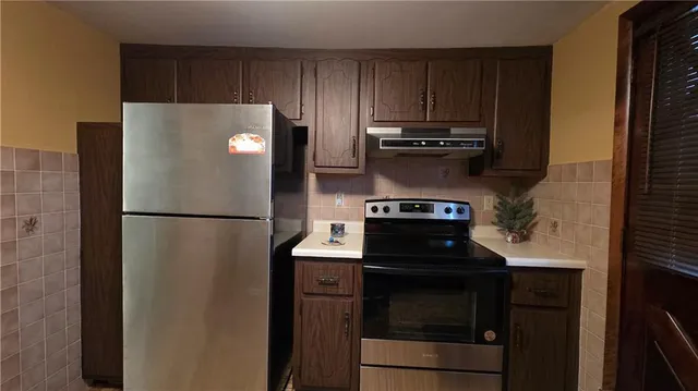a kitchen with a stove and a refrigerator