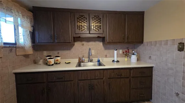 a kitchen with sink and cabinets