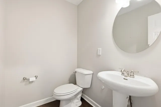 a bathroom with a sink toilet and a mirror