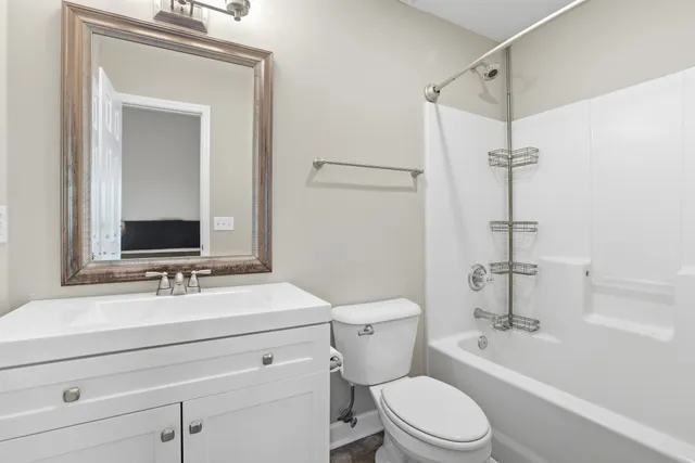 a bathroom with a sink vanity mirror and toilet