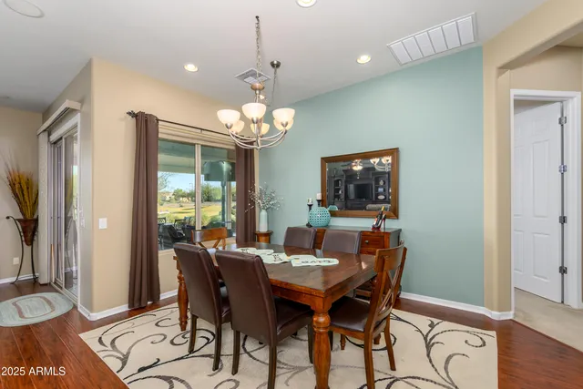 a view of a dining room with furniture wooden floor and chandelier