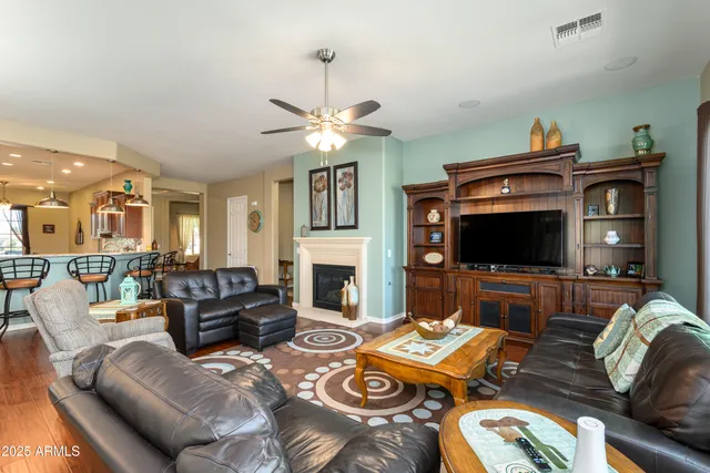 a living room with furniture a flat screen tv and a fireplace