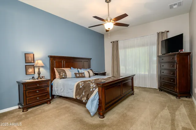 a bed room with a bed and a television