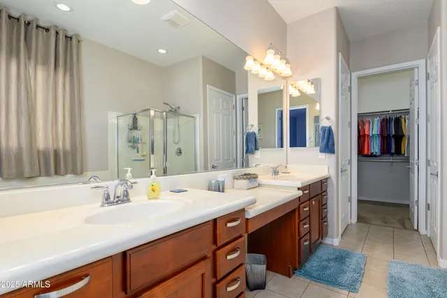 a bathroom with a double vanity sink and a mirror