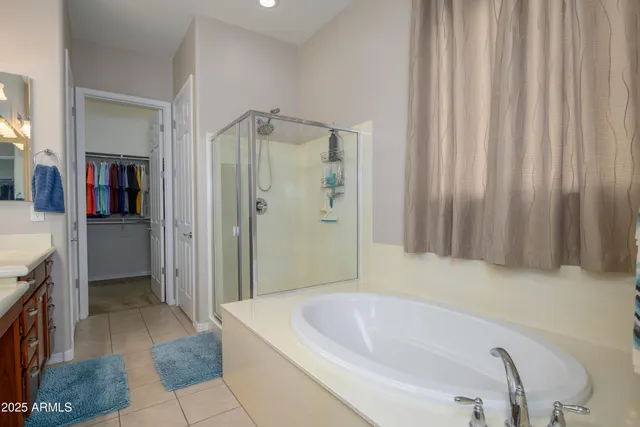 a bathroom with a tub a sink and shower