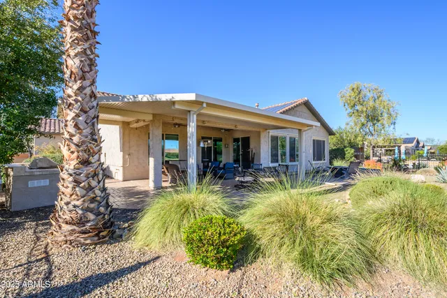 a view of a house with backyard outdoor seating area and entertaining space