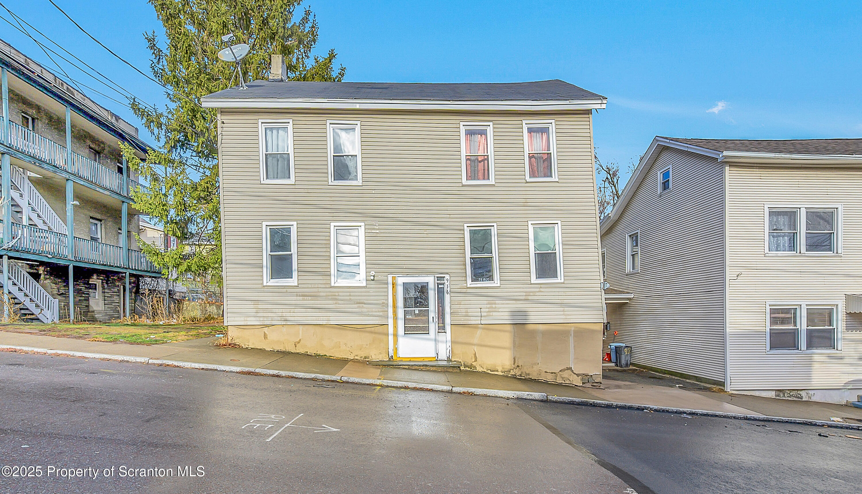 a front view of a house with a garden and a window