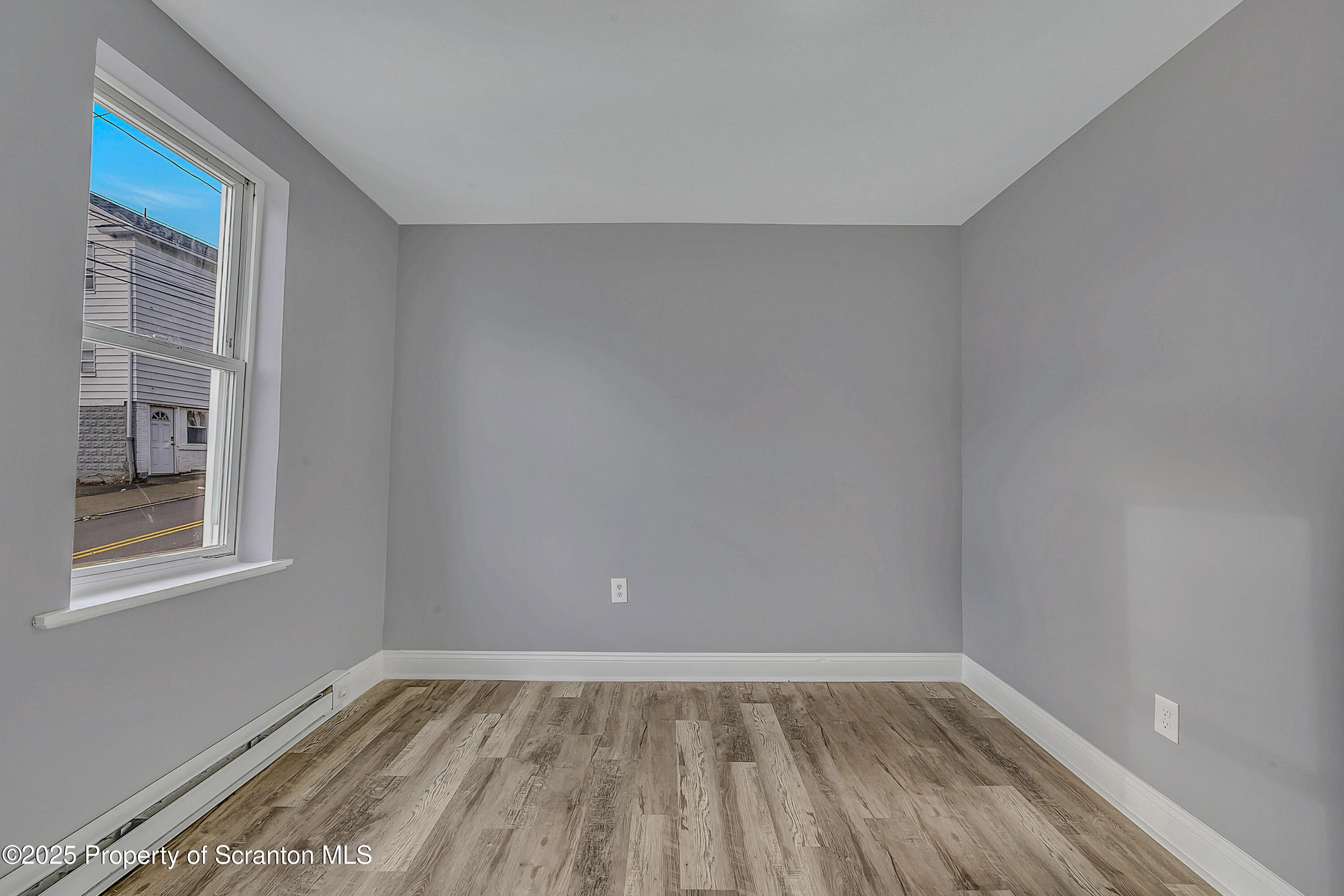 916 West Linden Street, Unit 1 Scranton, PA 18504 - Photo 11 of 19 a view of an empty room with wooden floor and a window