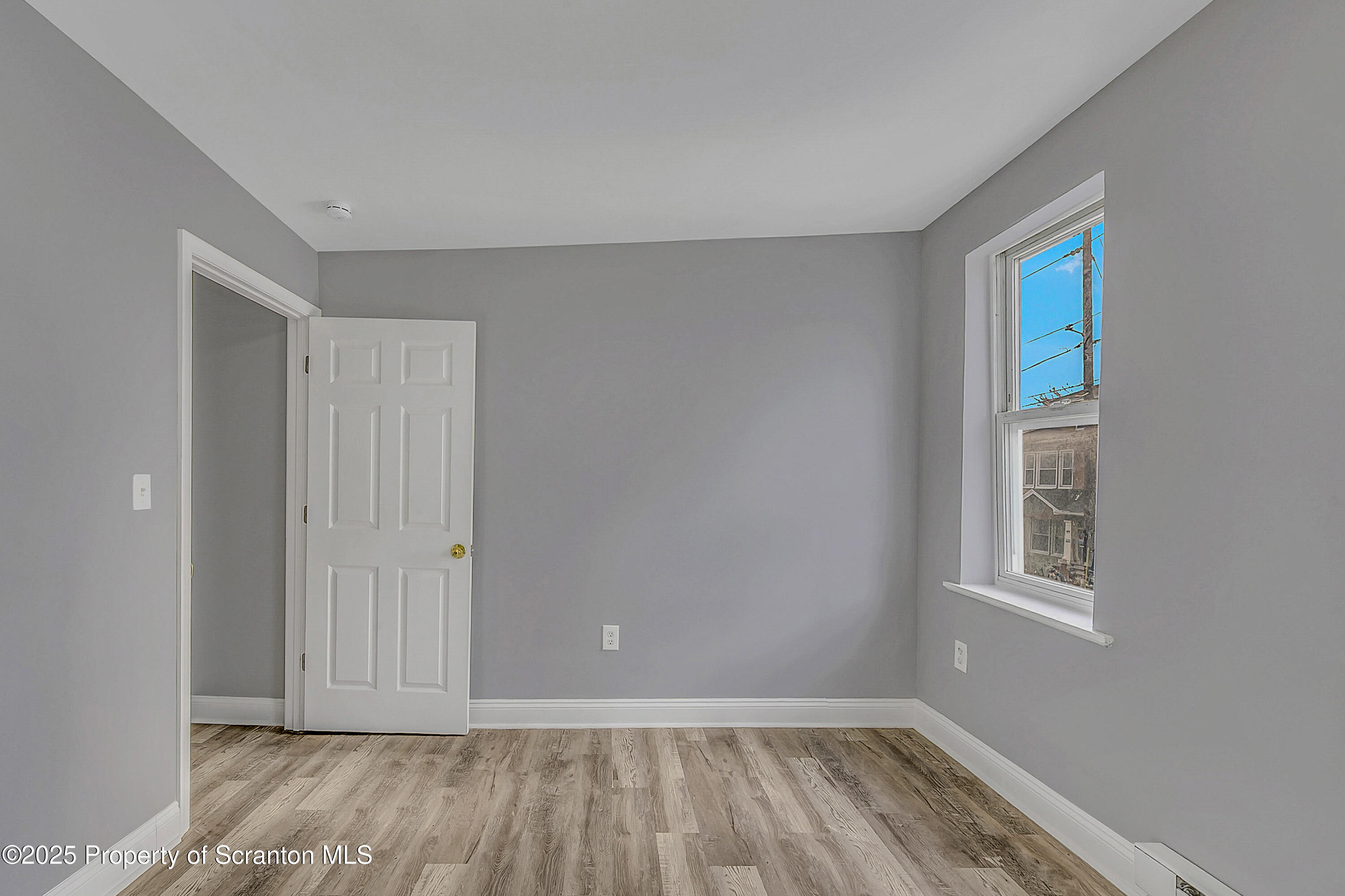 916 West Linden Street, Unit 1 Scranton, PA 18504 - Photo 12 of 19 a view of an empty room with wooden floor and a window