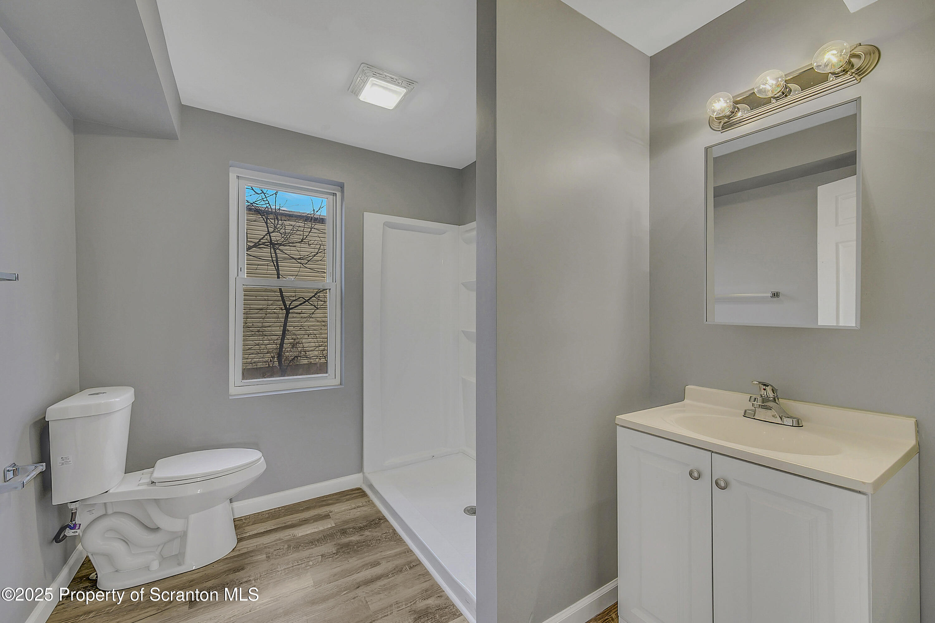 916 West Linden Street, Unit 1 Scranton, PA 18504 - Photo 15 of 19 a bathroom with a toilet sink and mirror