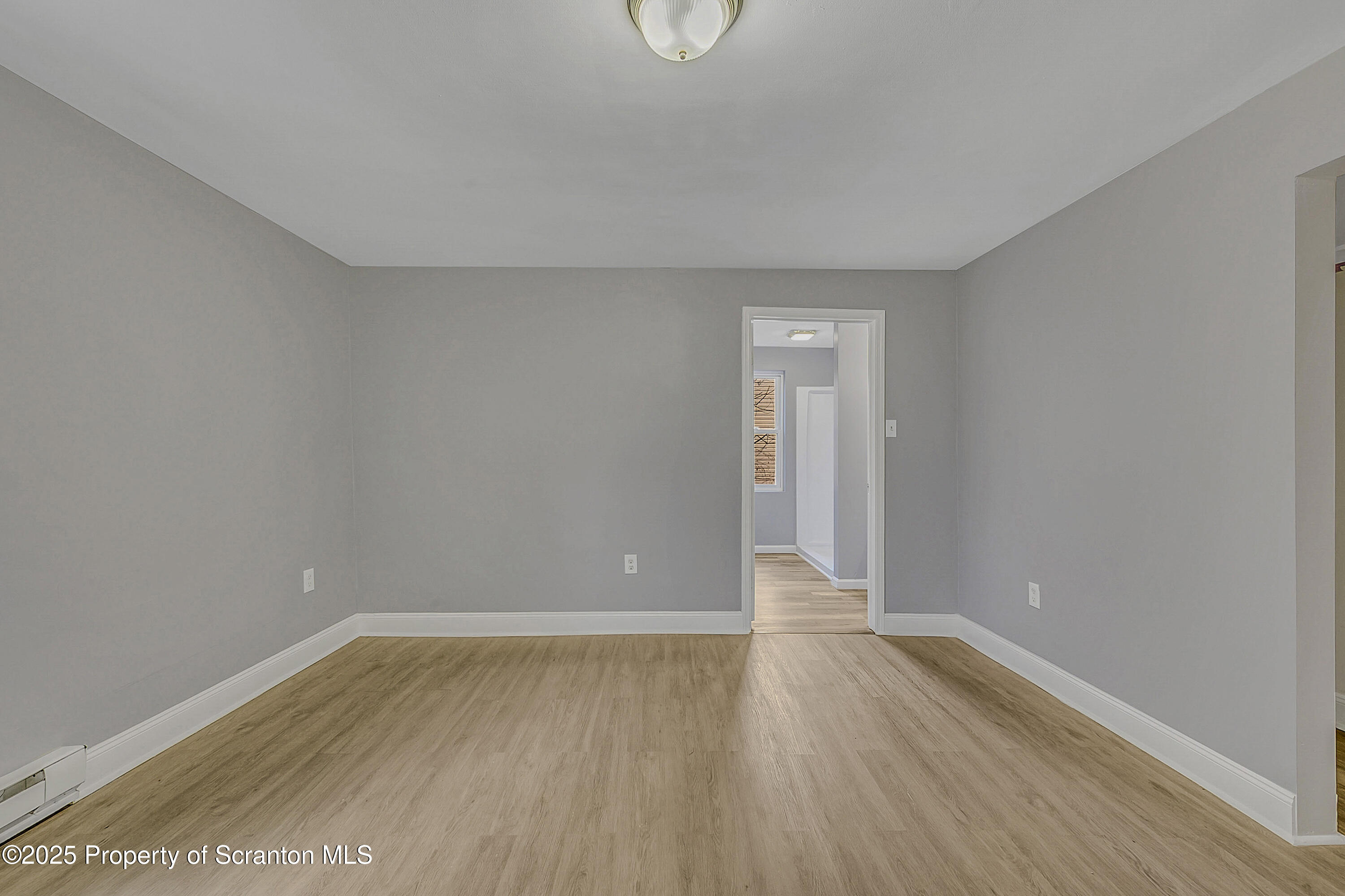 916 West Linden Street, Unit 1 Scranton, PA 18504 - Photo 18 of 19 a view of an empty room with wooden floor and windows