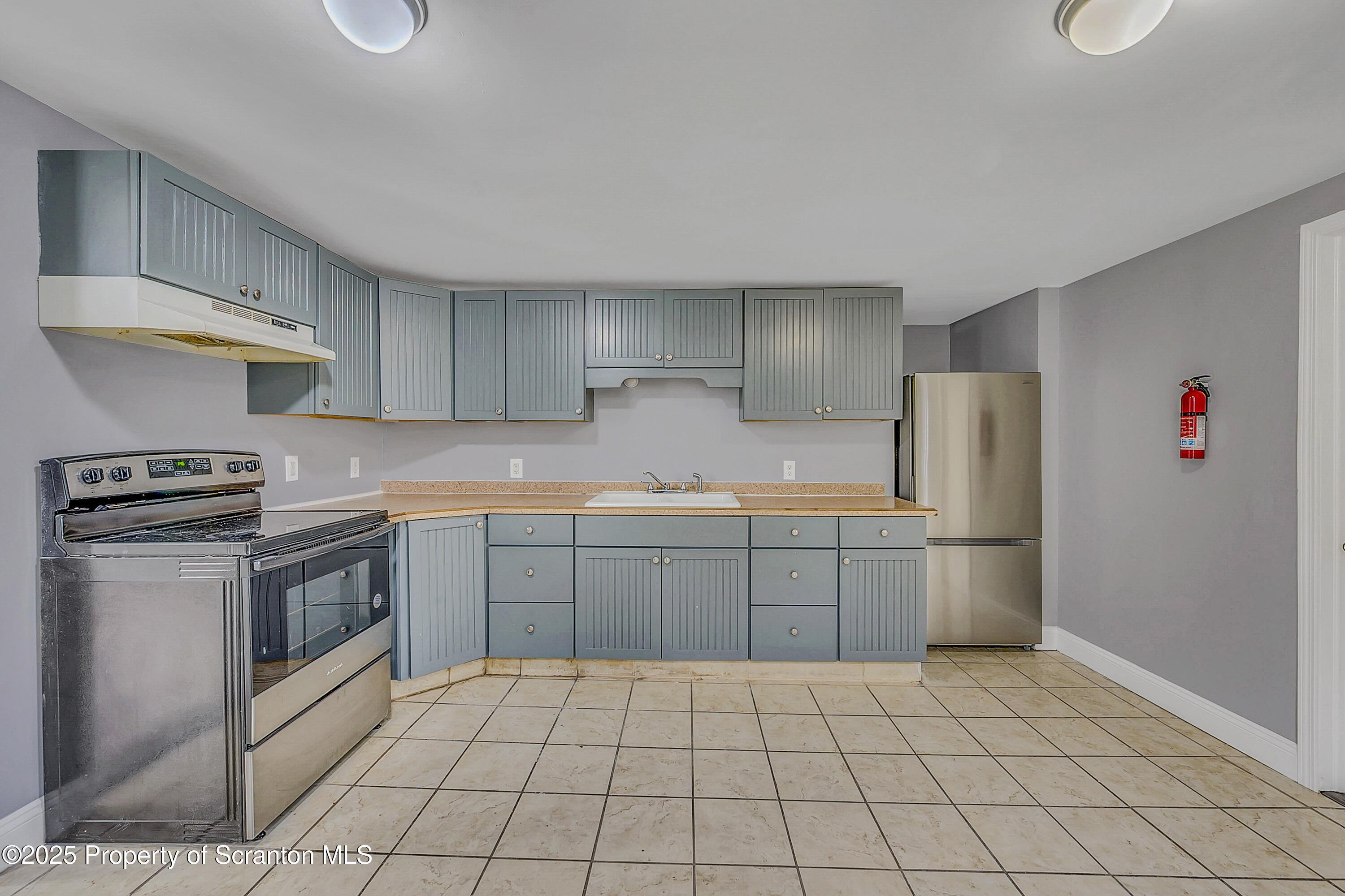 916 West Linden Street, Unit 1 Scranton, PA 18504 - Photo 4 of 19 a kitchen with a sink a stove top oven and cabinets