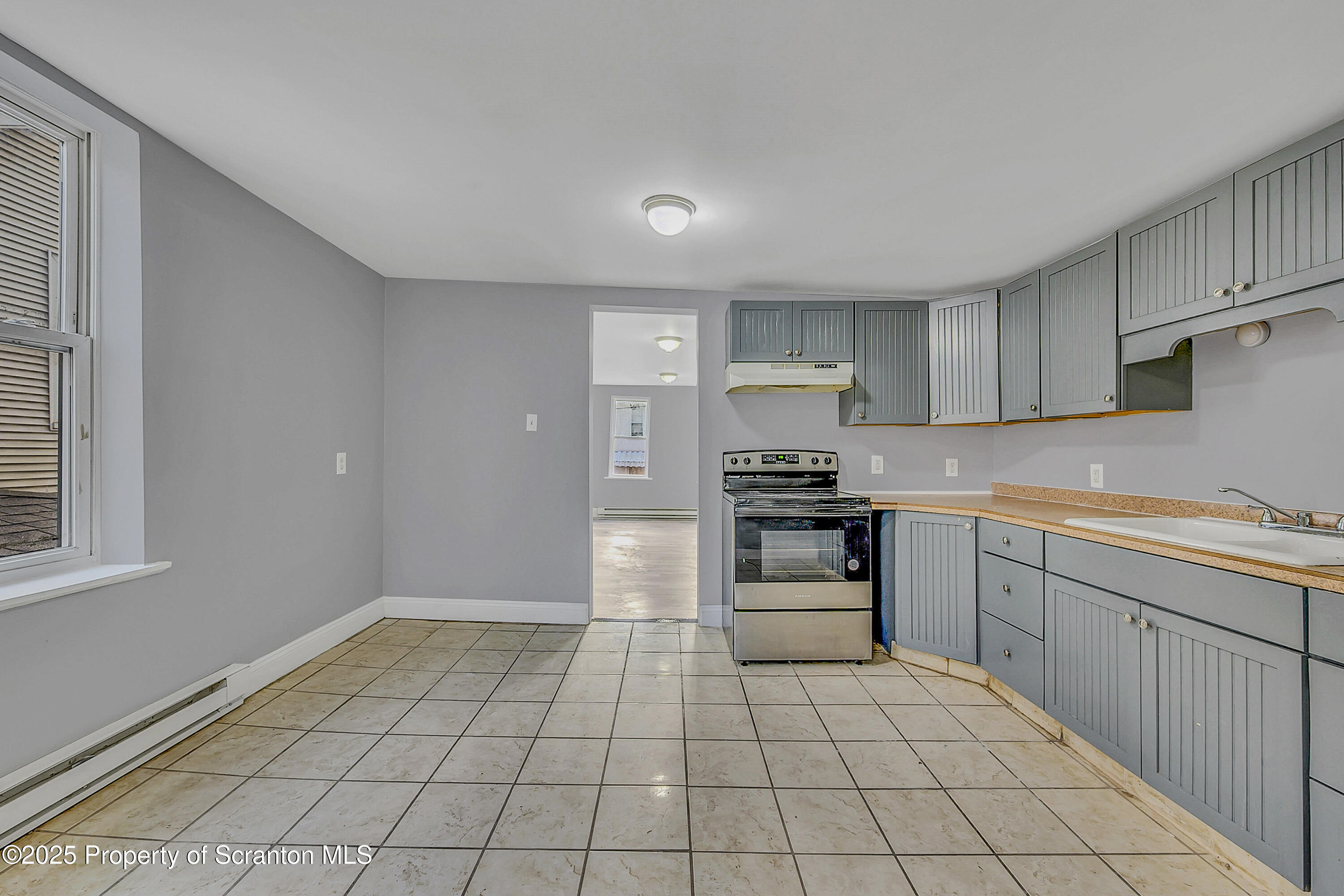 916 West Linden Street, Unit 1 Scranton, PA 18504 - Photo 6 of 19 a kitchen with a stove a sink and a refrigerator