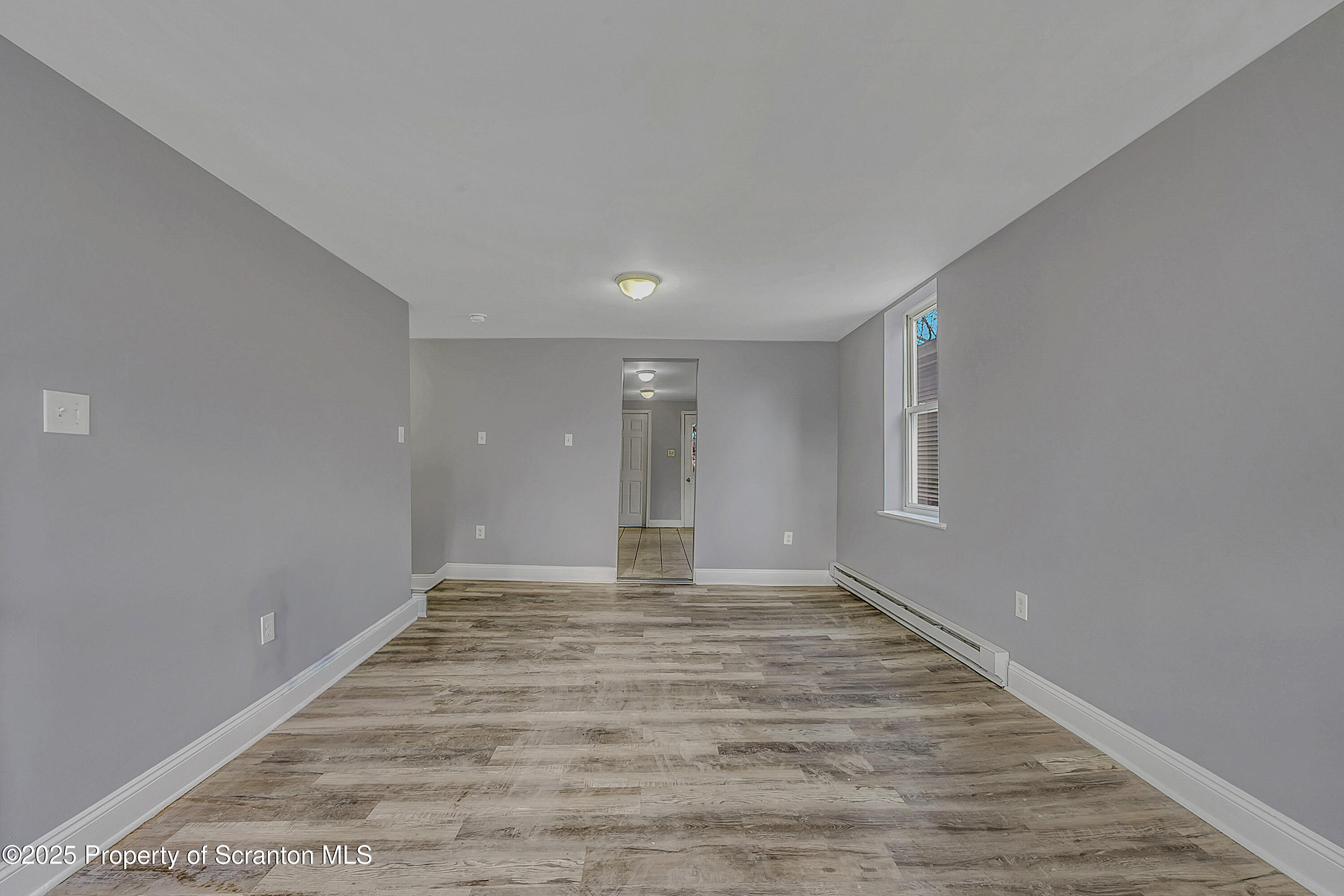 916 West Linden Street, Unit 1 Scranton, PA 18504 - Photo 8 of 19 a view of an empty room with window and wooden floor