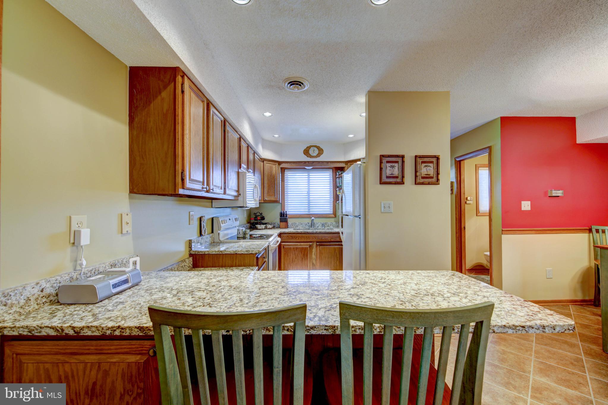 13800 Barge Road, Unit 7 Ocean City, MD 21842 - Photo 10 of 28 Breakfast bar into the kitchen
