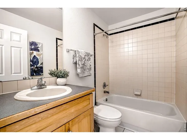 a view of a livingroom with wooden floor and a potted plant