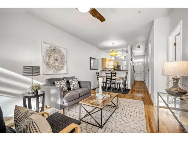 a dining room filled chandelier and wooden floor