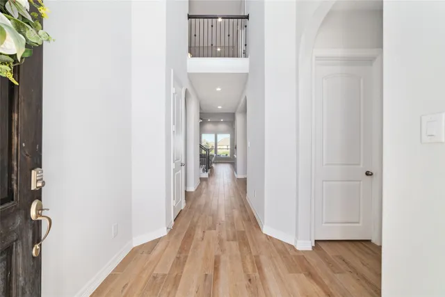 a view of a hallway with wooden floor