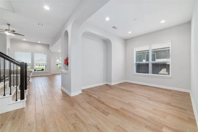 a view of empty room with wooden floor