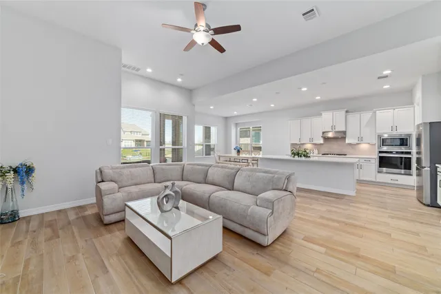 a living room with furniture and kitchen view