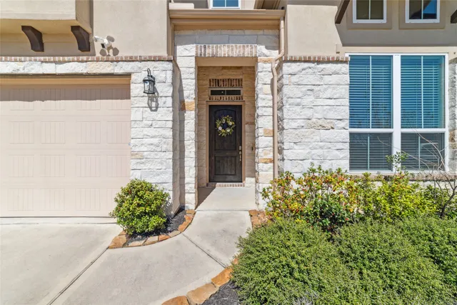 a front view of a house with potted plants