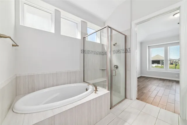 a bathroom with a bathtub and a shower