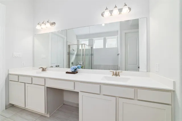 a bathroom with a sink vanity and a mirror