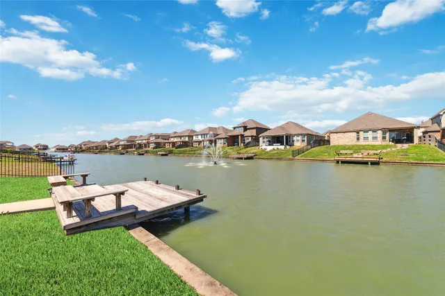 a view of a lake with houses in the back
