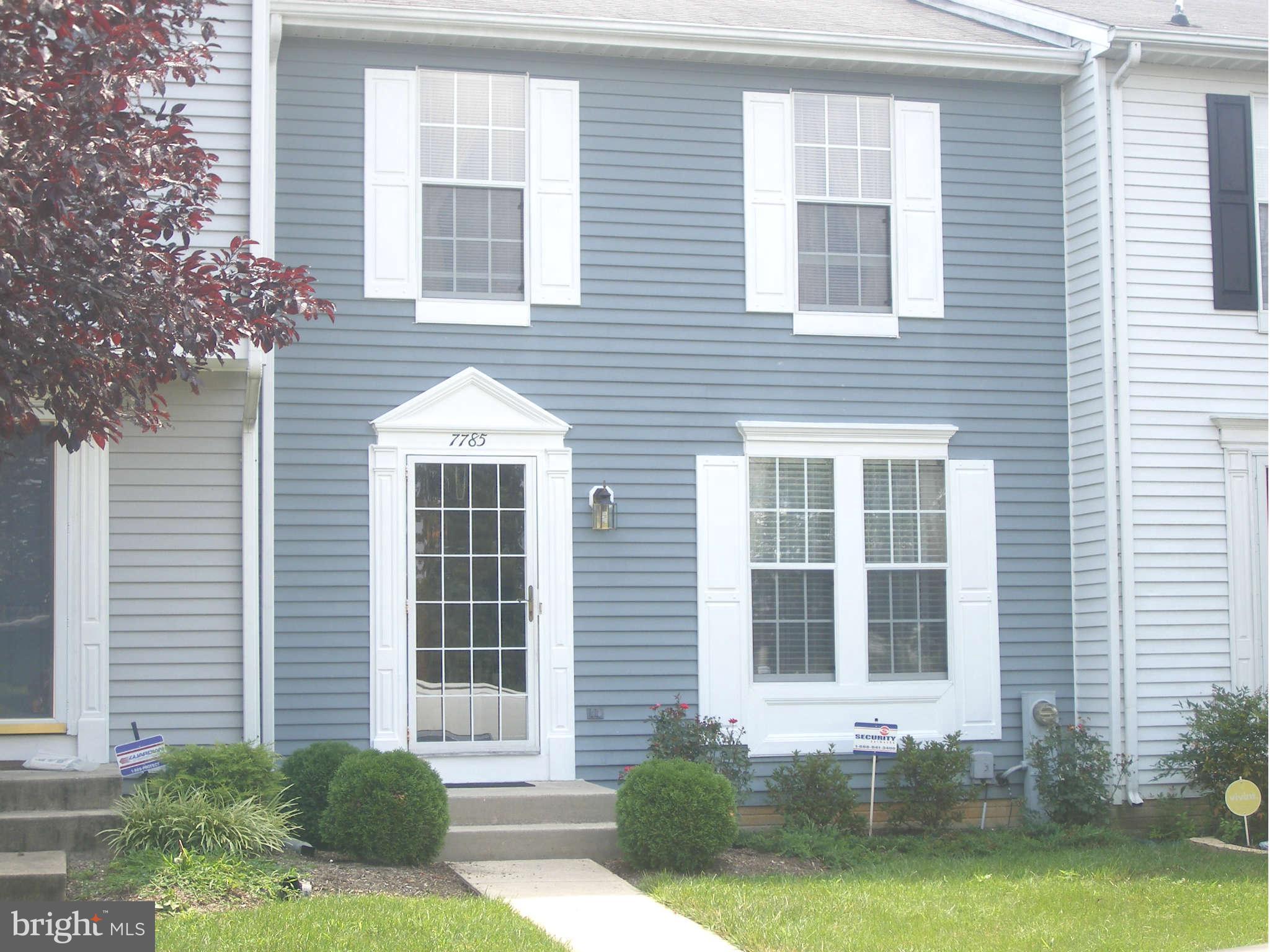7785 Paddock Way Baltimore, MD 21244 - Photo 1 of 30 a front view of a house with garden