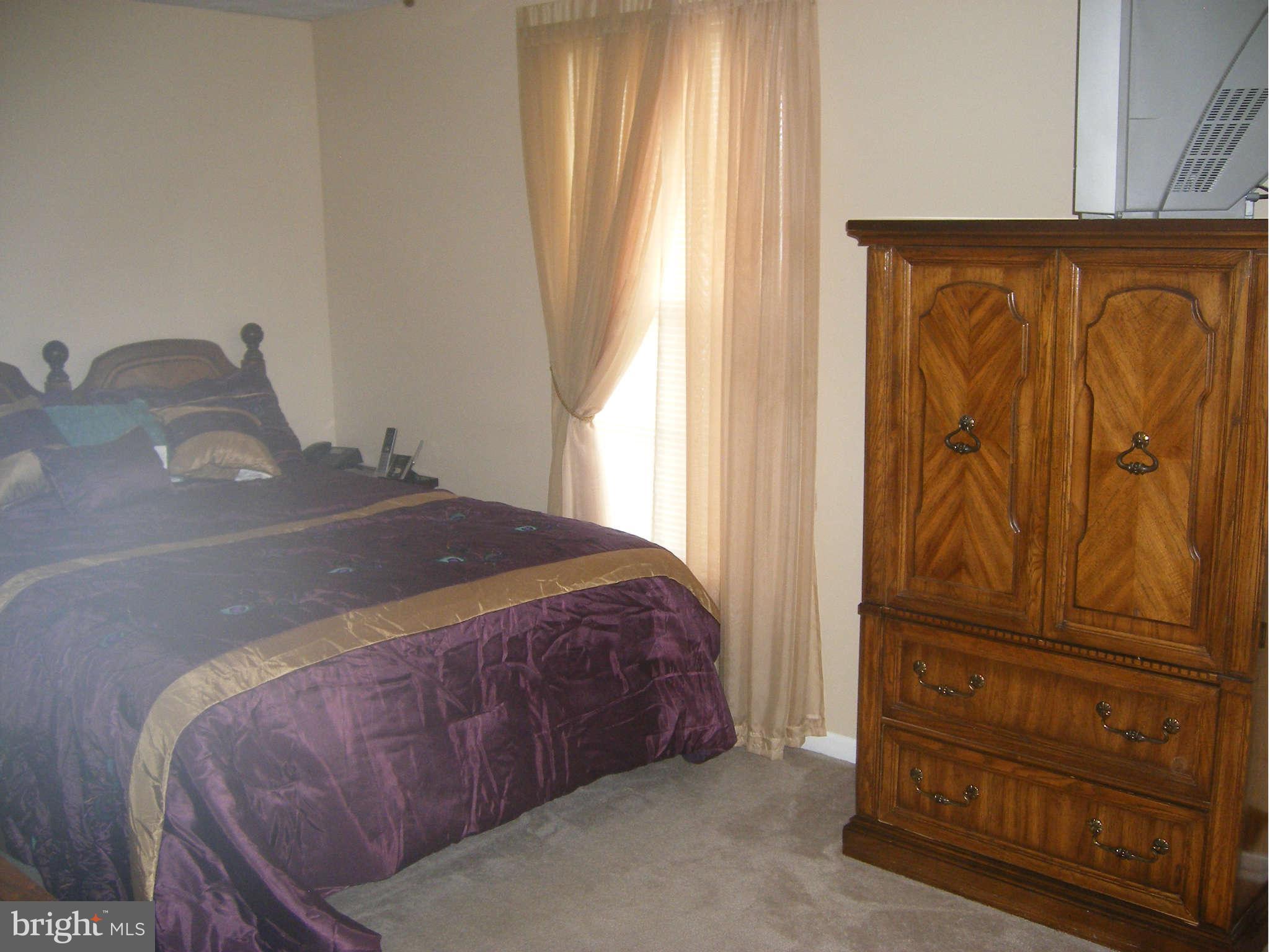 7785 Paddock Way Baltimore, MD 21244 - Photo 12 of 30 a bedroom with a bed and a cabinet