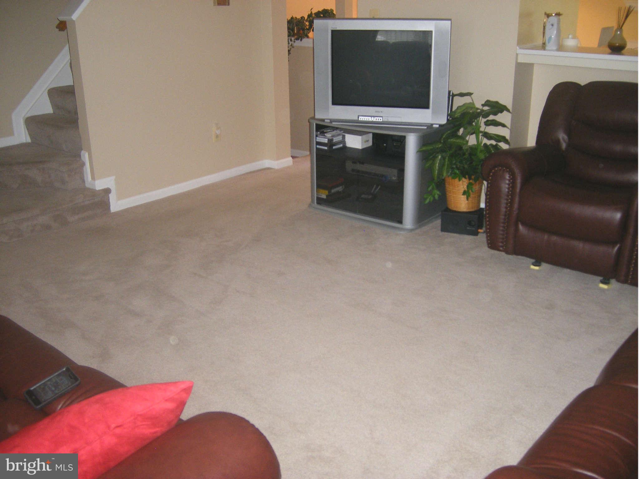 7785 Paddock Way Baltimore, MD 21244 - Photo 20 of 30 a living room with furniture a flat screen tv and a fireplace