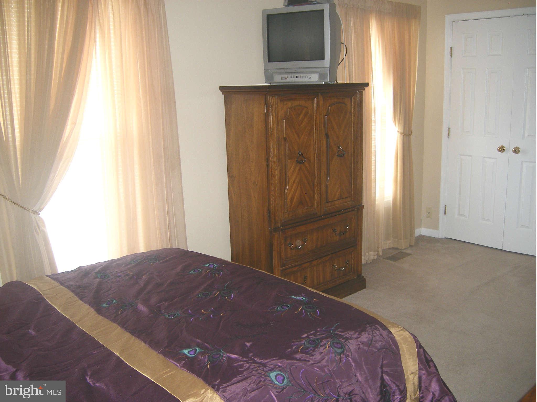 7785 Paddock Way Baltimore, MD 21244 - Photo 30 of 30 a bedroom with a bed and flat screen tv